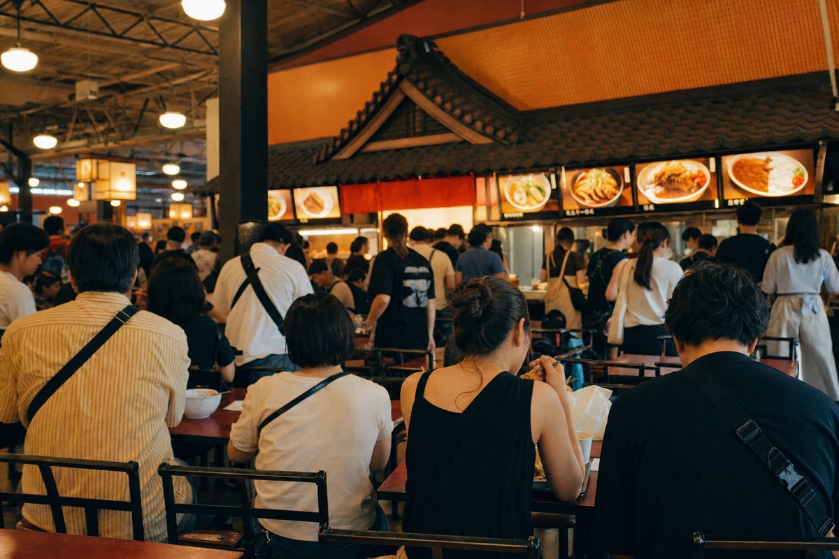 Themed food court inside a Japanese amusement park with ramen and curry counters