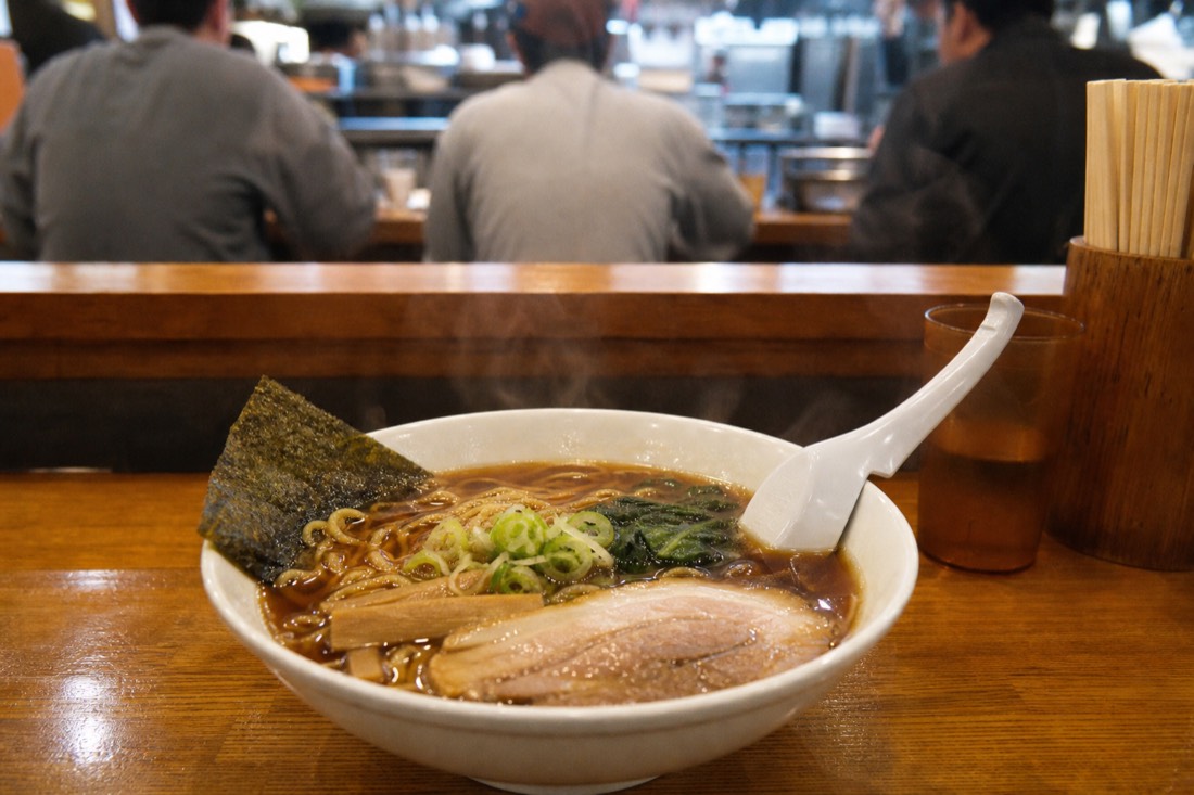 A bowl of shoyu ramen at the Fuji-Q Highland food court, near the vegan options at T's