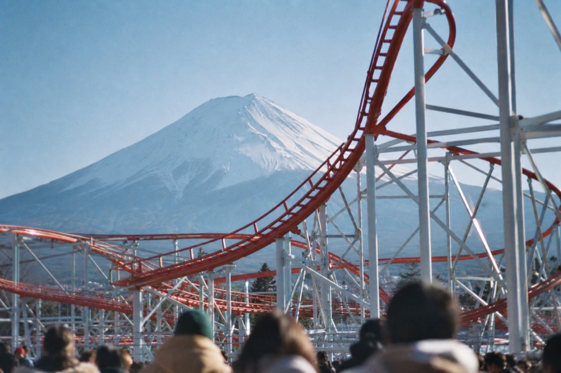 Red and white coaster steel with Mount Fuji rising behind Fuji-Q Highland