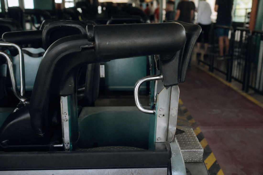 Over-shoulder restraint harness on an empty coaster seat row