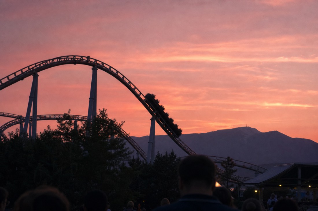 Coaster silhouette against a golden-hour sky at the foot of Mount Fuji