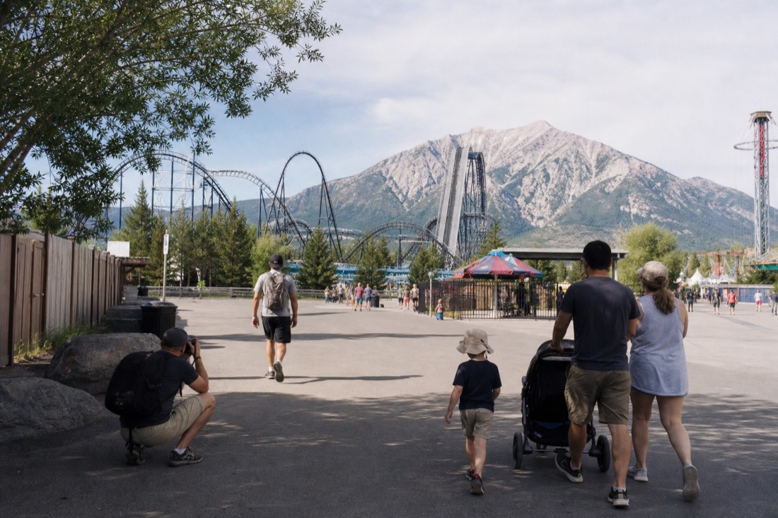 A coaster enthusiast, a family with young children and a photographer taking separate paths through a Fuji-Q Highland midway