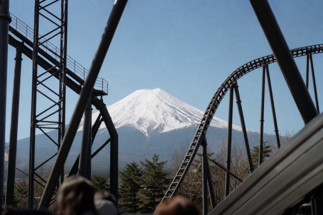 Mount Fuji framed between Fuji-Q Highland coaster structures