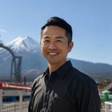 Kenji Yamamoto, Fuji-Q Highland ticket specialist, with Mount Fuji behind him
